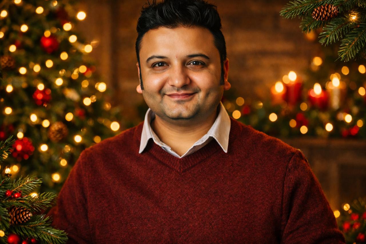 Harshit, smiling, in a burgundy sweater